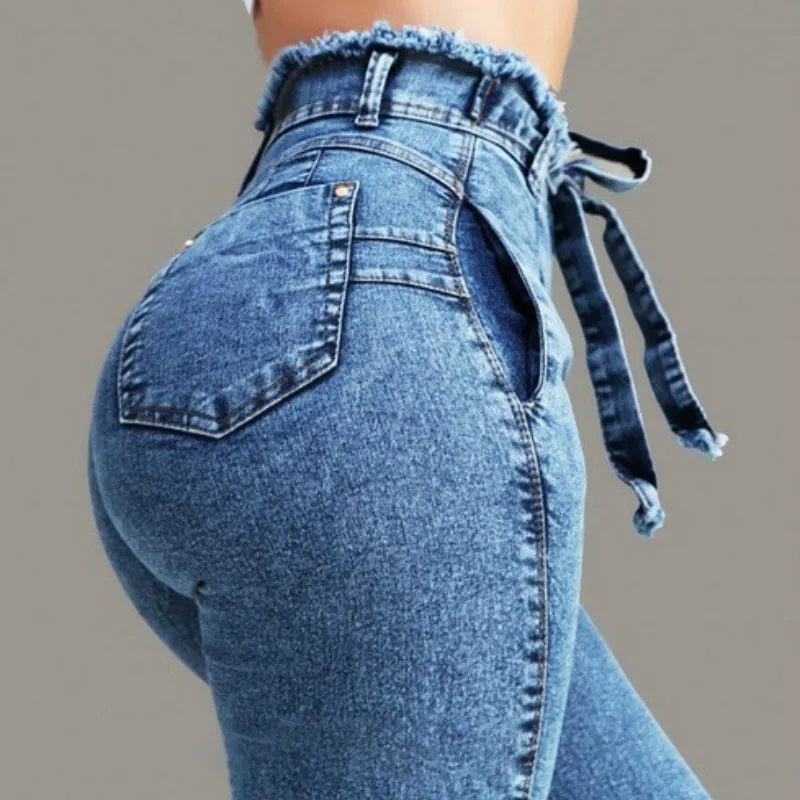 Pair of women's light blue straight-leg jeans with a frayed, distressed hem detail.