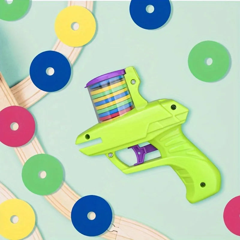 Interactive cat toy launcher firing foam disc with green plastic construction