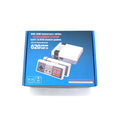 Red and grey NES retro mini game console with two rectangular controllers on a table.