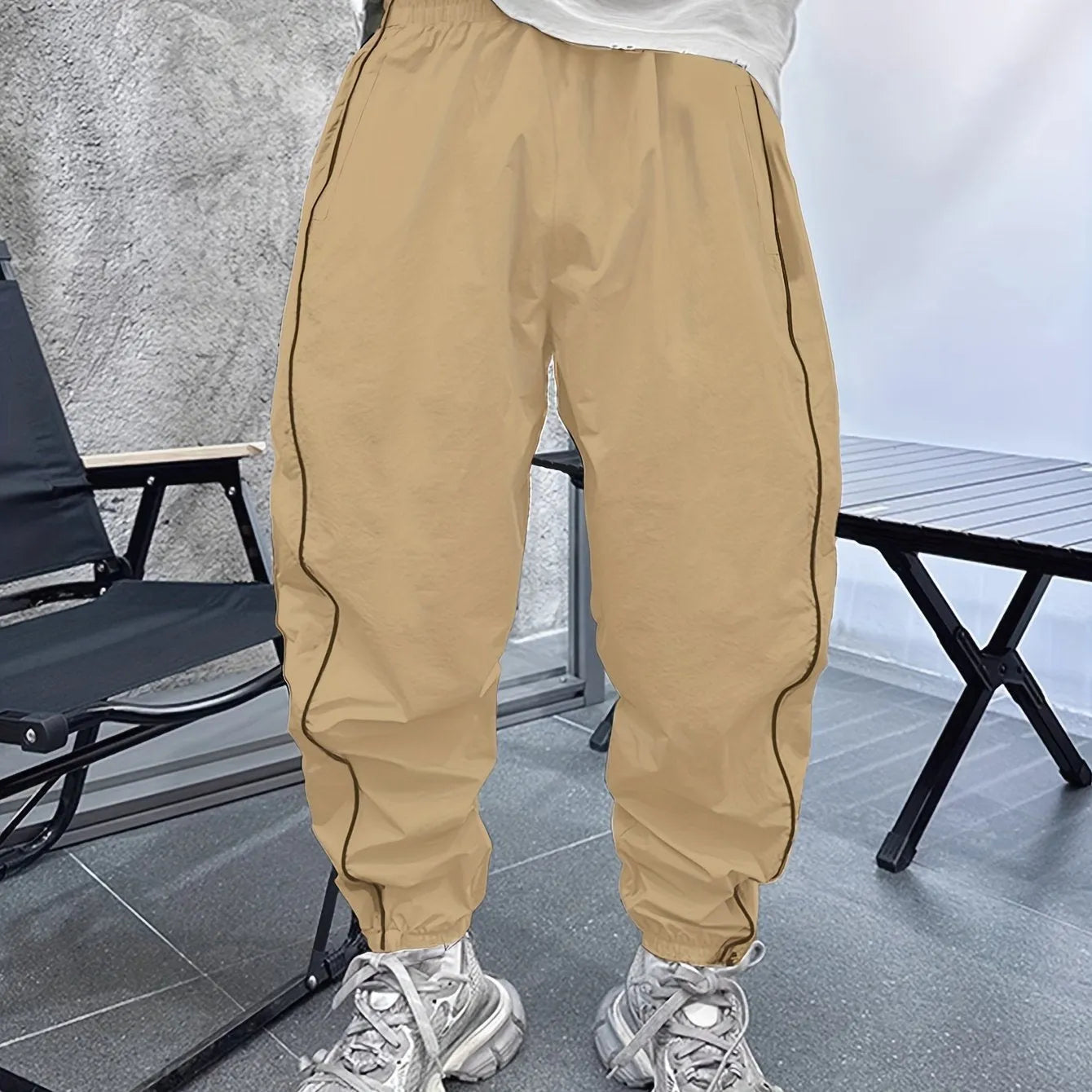 Men's blue bamboo fibre cropped sports trousers with a loose casual fit on a hanger.
