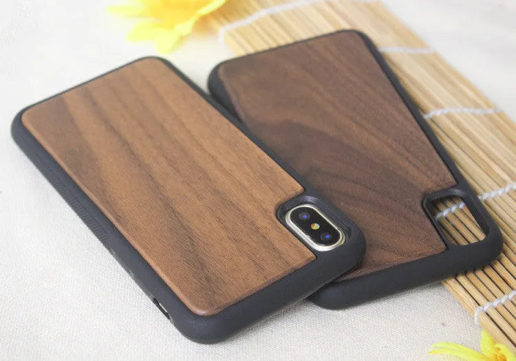 Wooden carbonised bamboo and black TPU bumper case for iPhone on a wooden table.