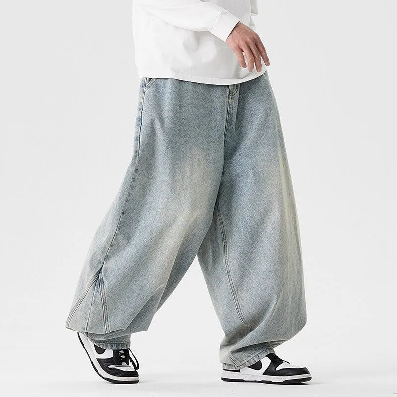Men's plus size light blue wide leg baggy jeans on a neutral background