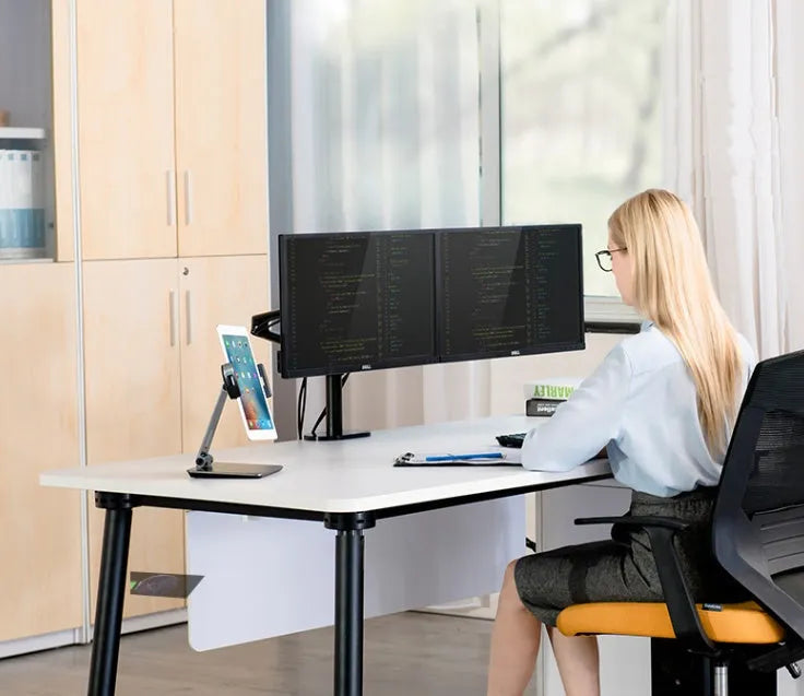 Folding aluminium phone and tablet stand on a desk, shown in silver colour with 360-degree rotation.