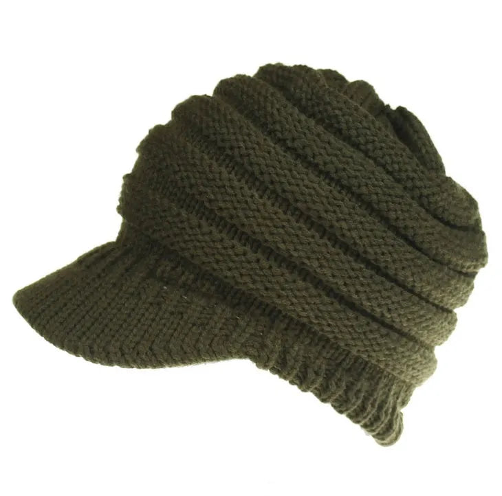 Woman wearing a soft knitted beanie with a ponytail pulled through the hole at the back.