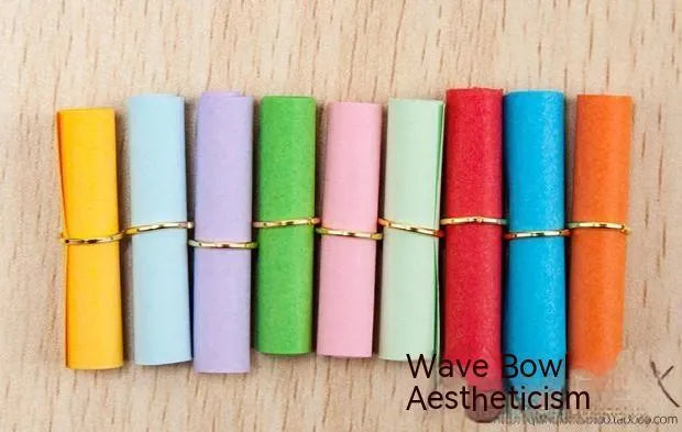 Colourful assortment of small paper scrolls with metal eyelets for drift bottle messages.