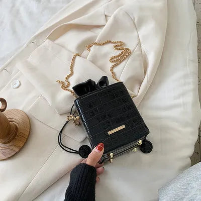 Small black PU leather women's chain messenger bucket bag with a single strap and zip opening.