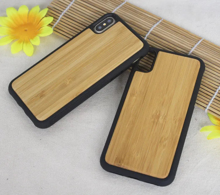 Wooden carbonised bamboo and black TPU bumper case for iPhone on a wooden table.