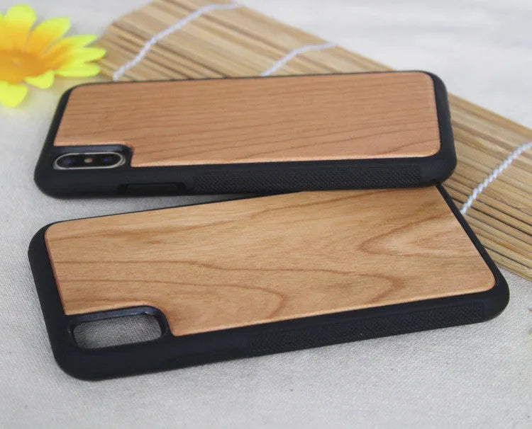 Wooden carbonised bamboo and black TPU bumper case for iPhone on a wooden table.