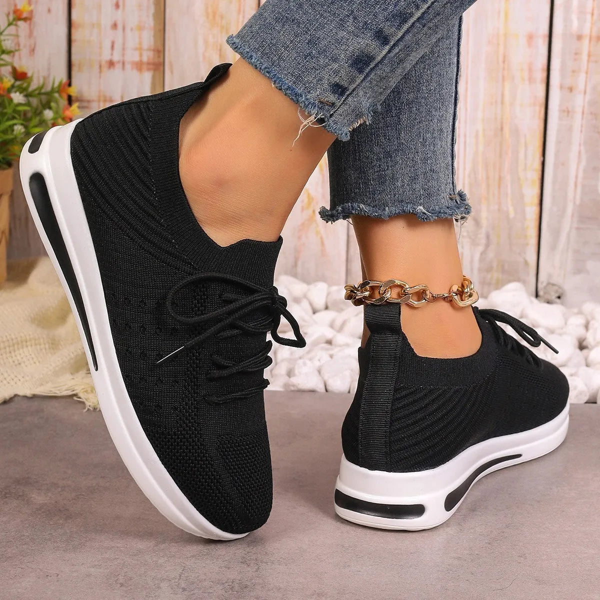 Women's low-top red fly-knit sneakers with round toe and white injection moulded sole on a light background.