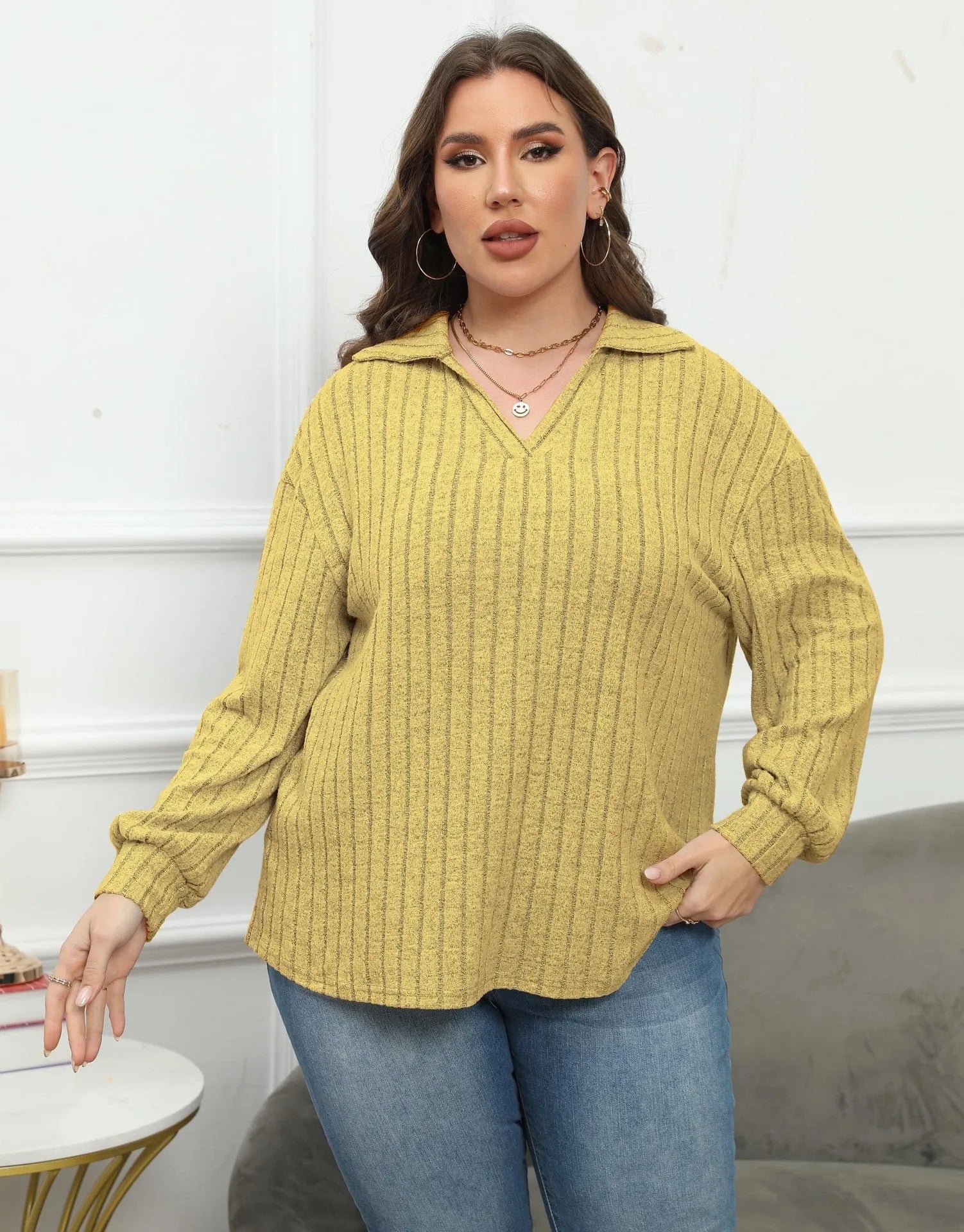 Women's plus size gray fleece pullover with a polo collar and full lantern sleeves.