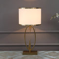 White Nordic style bedside lamp with drum shape and Phnom Penh trumpet design on a wooden table