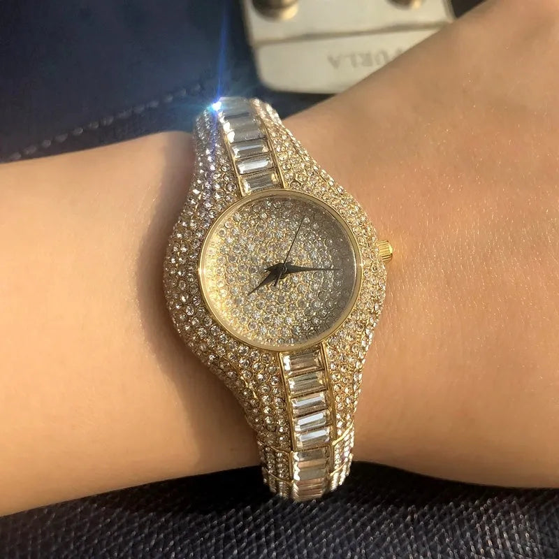 Gold alloy quartz women's watch with round dial, mineral glass mirror, and decorative inlay on brown background