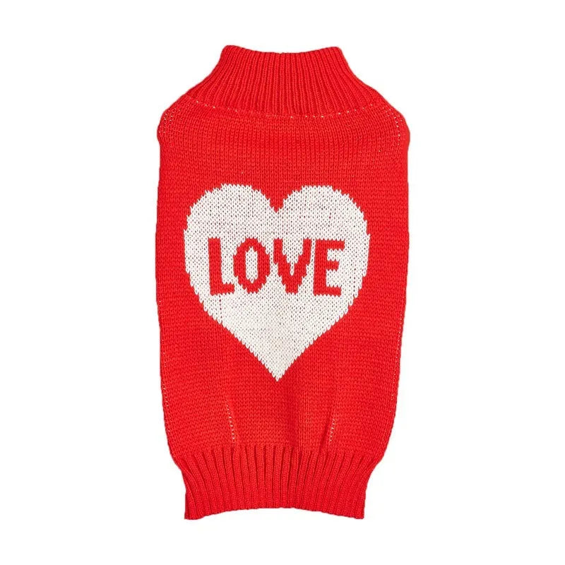 Dog wearing acrylic jumper with love heart and bow designs in red and pink colour patterns