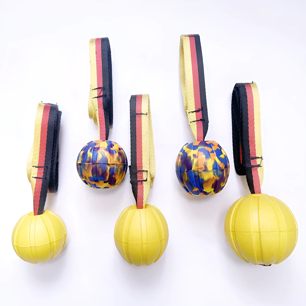 Floating camouflage and yellow EVA pet training ball with knotted tether in three diameter sizes for water retrieval
