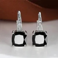 Square geometric ear hook earrings with zircon stones in an electroplated copper setting.