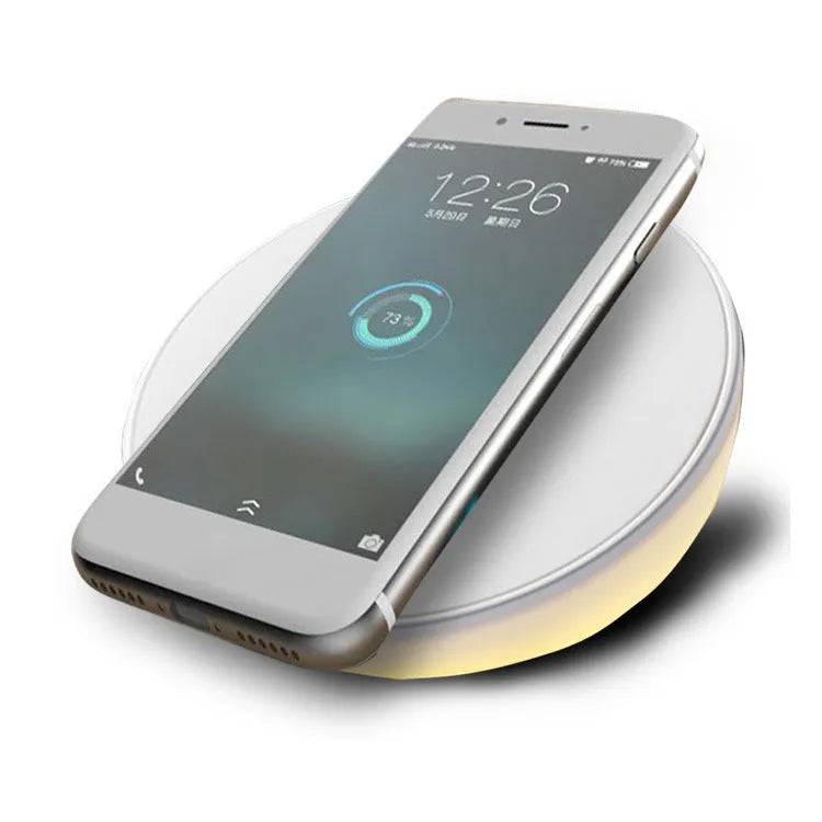 White wireless phone charger with digital clock display, three control buttons, and LED night light