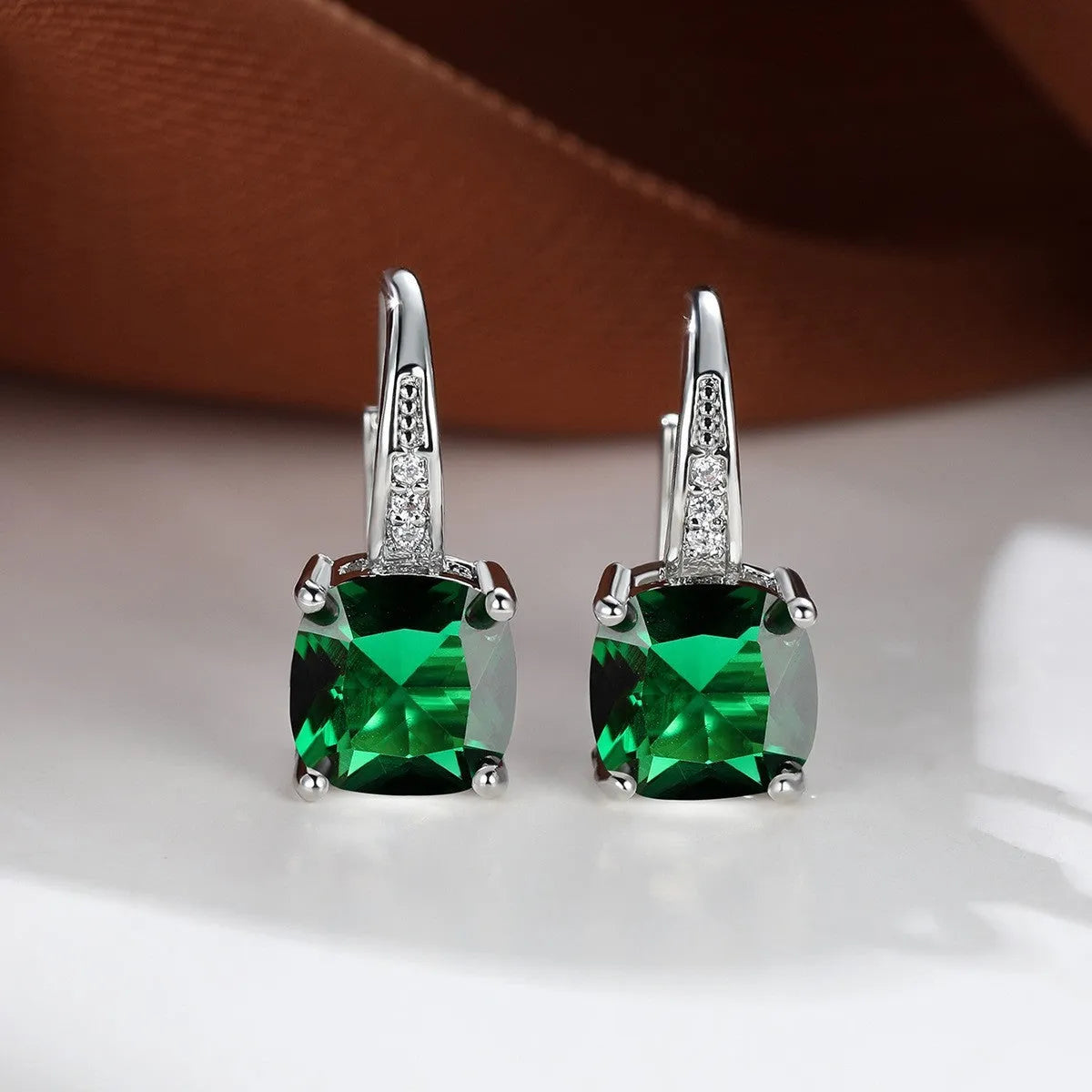 Square geometric ear hook earrings with zircon stones in an electroplated copper setting.
