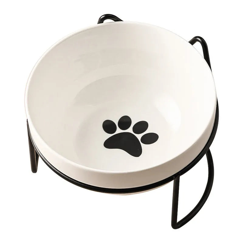 White ceramic cat bowl with cat paw print pattern in a black iron cat-ear frame