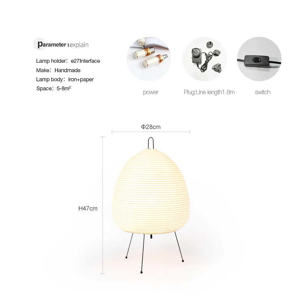 Japanese style handmade rice paper lantern table lamp with aluminium base on a wooden table.