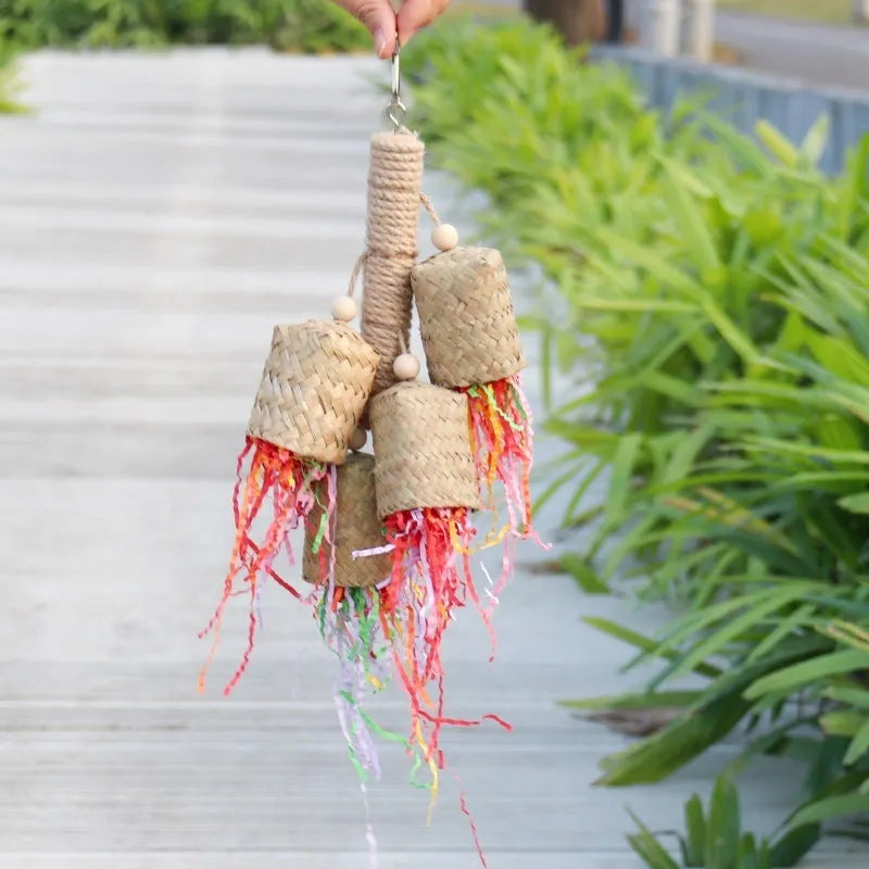 Wooden parrot chew toy with colourful shredded paper hanging from sisal rope