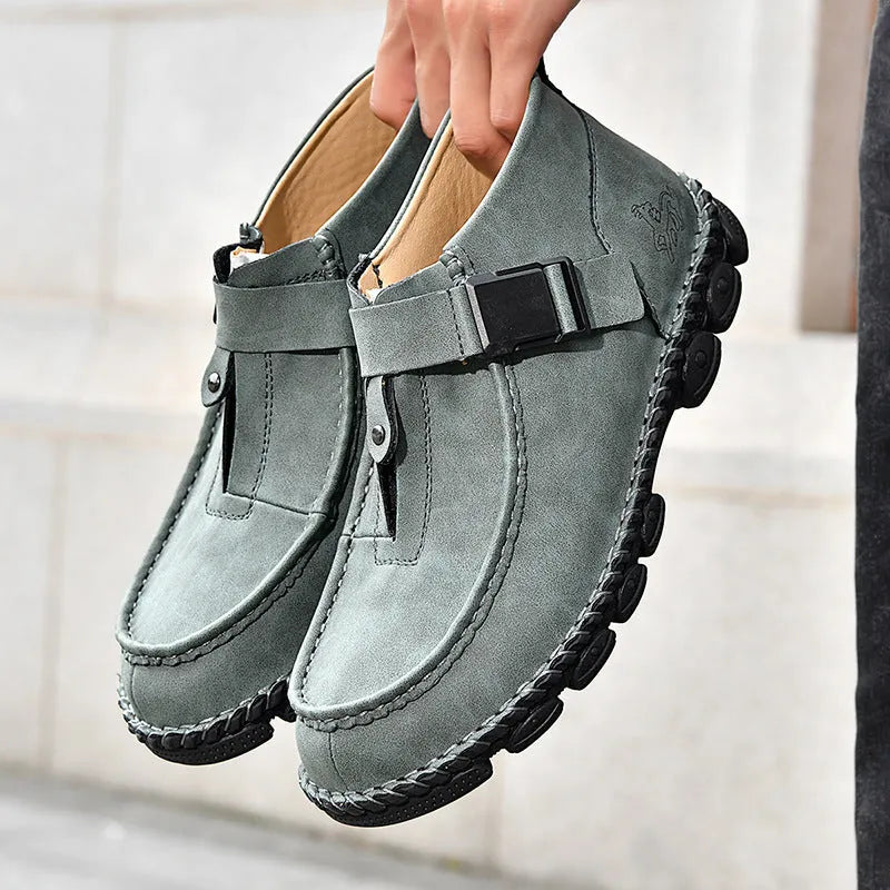 Black synthetic leather slip-on flat shoes with handmade stitching on the sole