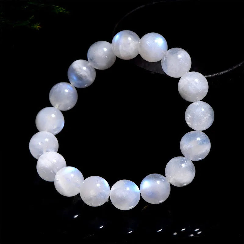 Natural blue moonlight round bead moonstone bracelet showing polished stone beads on wrist