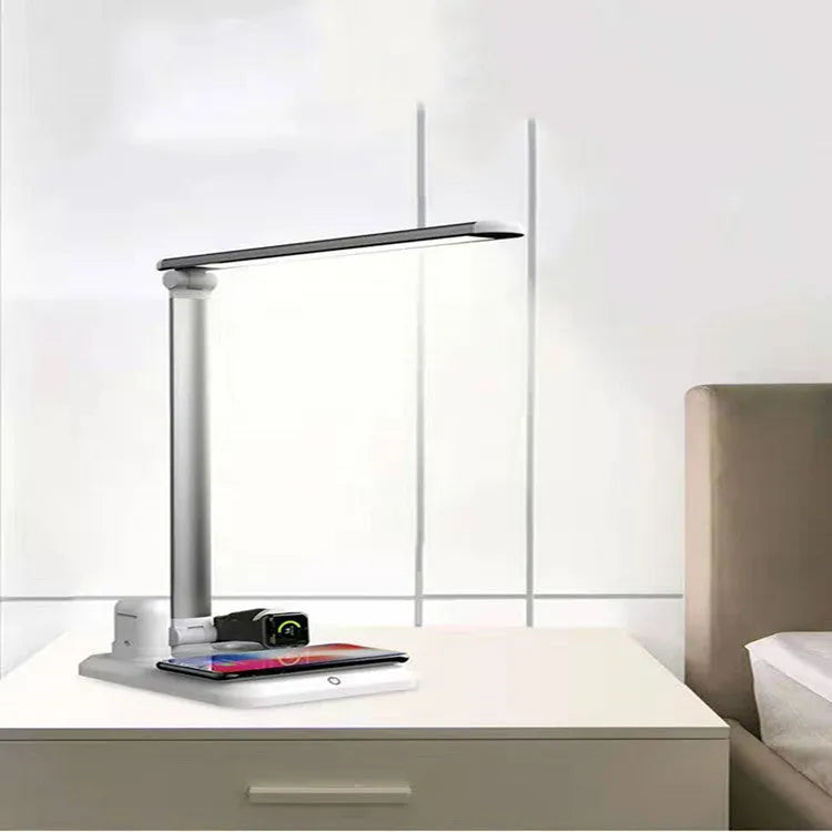 Black and white 4-in-1 LED desk lamp with integrated wireless charging pad.