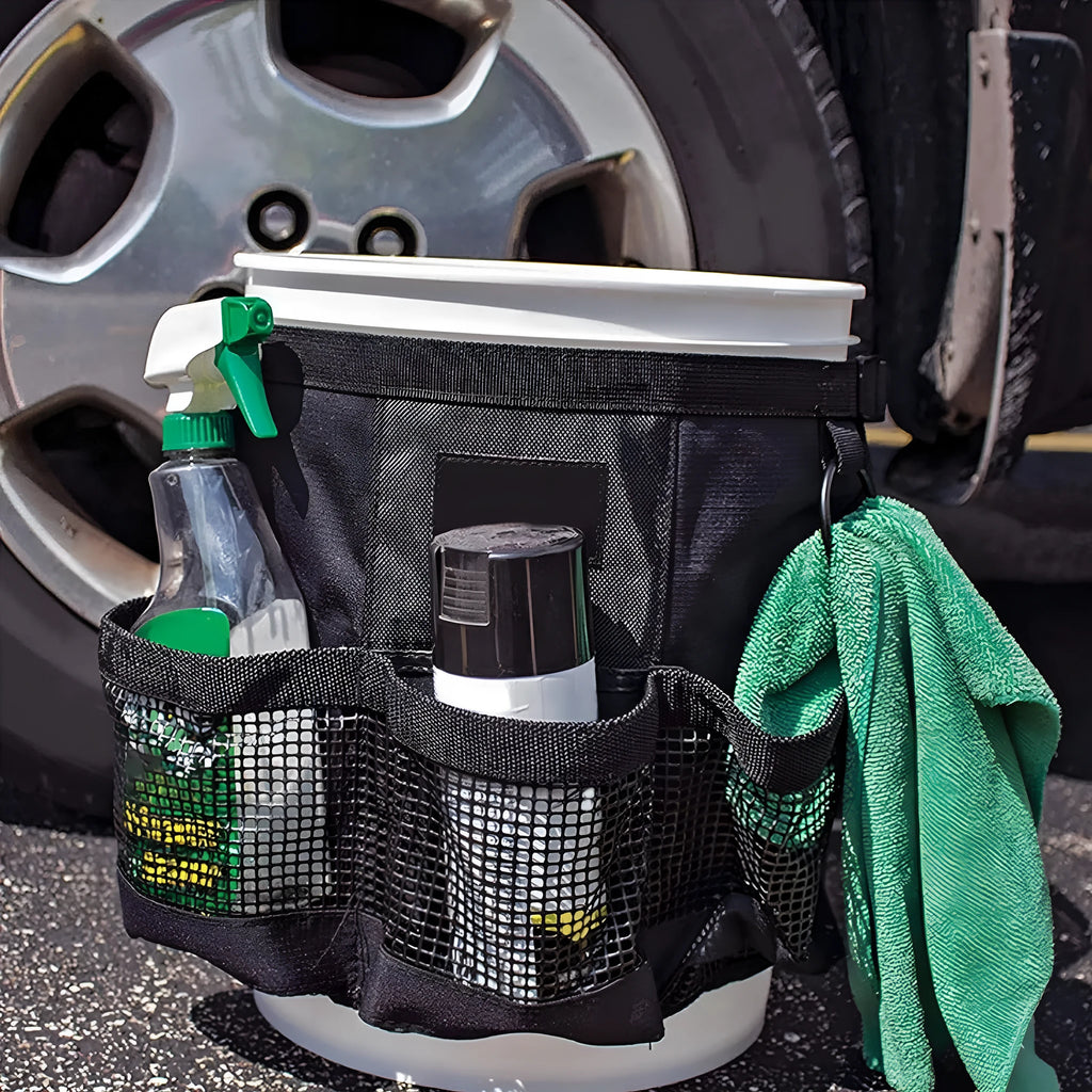Black cylindrical polyester hanging storage bag fitted on a 5 gallon drum, holding car washing tools.