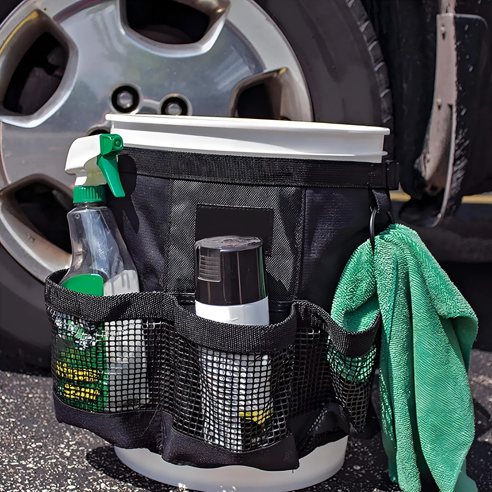Black cylindrical polyester hanging storage bag fitted on a 5 gallon drum, holding car washing tools.