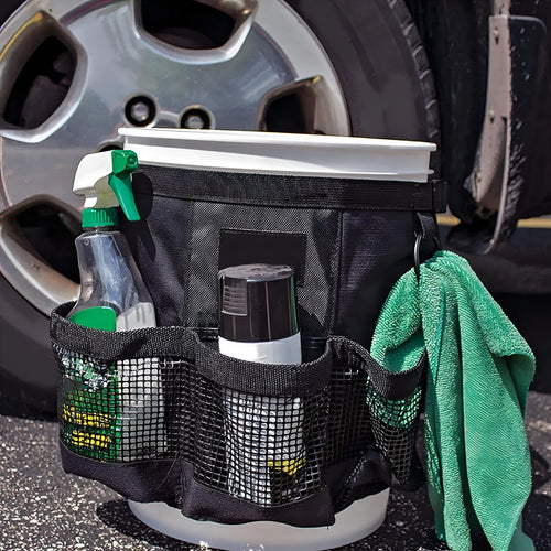 Black cylindrical polyester hanging storage bag fitted on a 5 gallon drum, holding car washing tools.