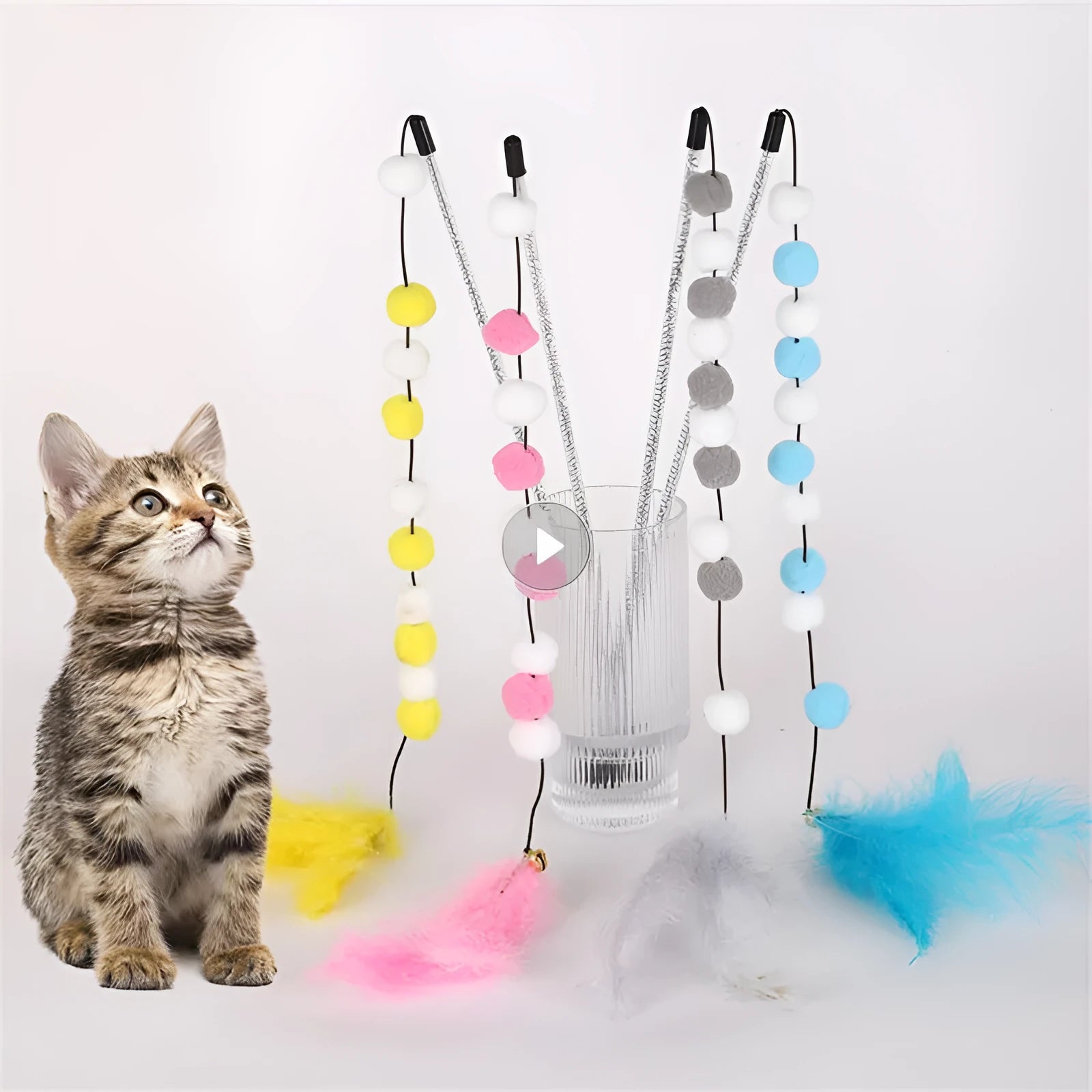 Set of four colourful cat teaser toy rods with feathers, pompons and bells.