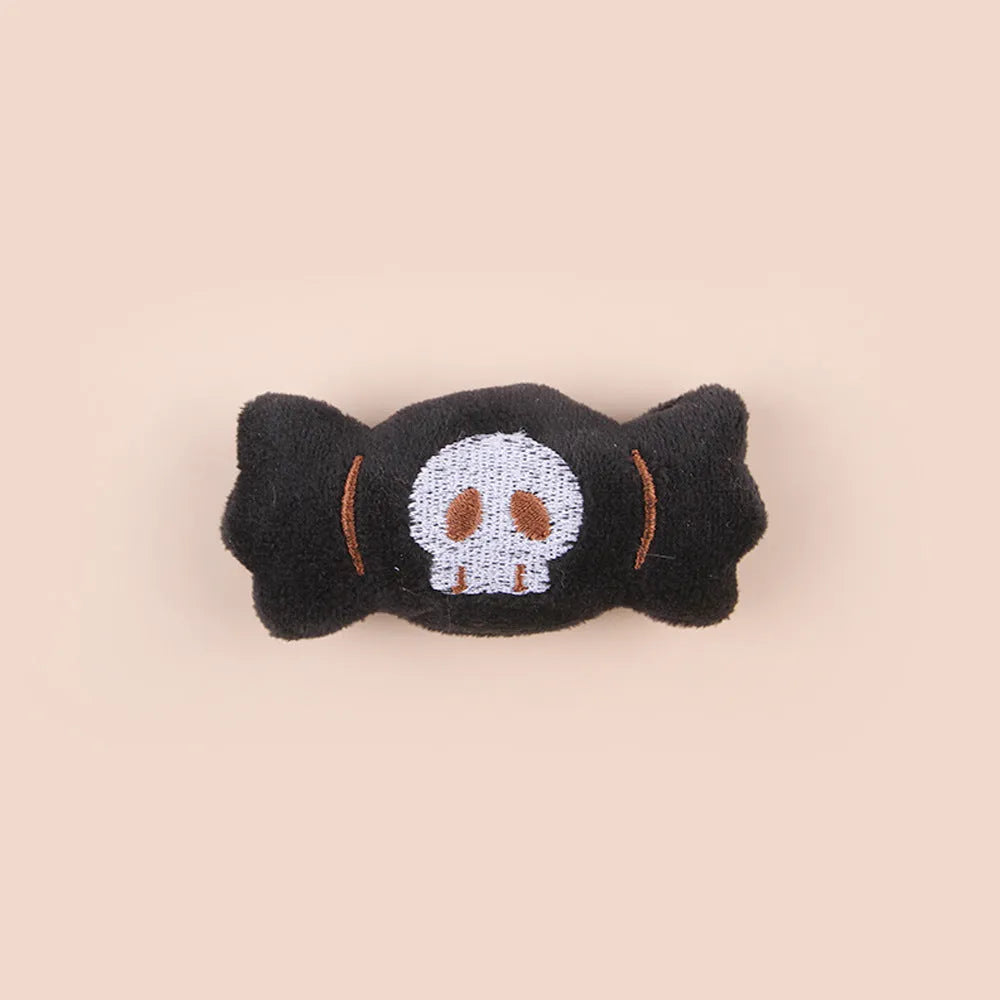 Small plush cat teaser toy with candy and skull designs in eyes or candy colours
