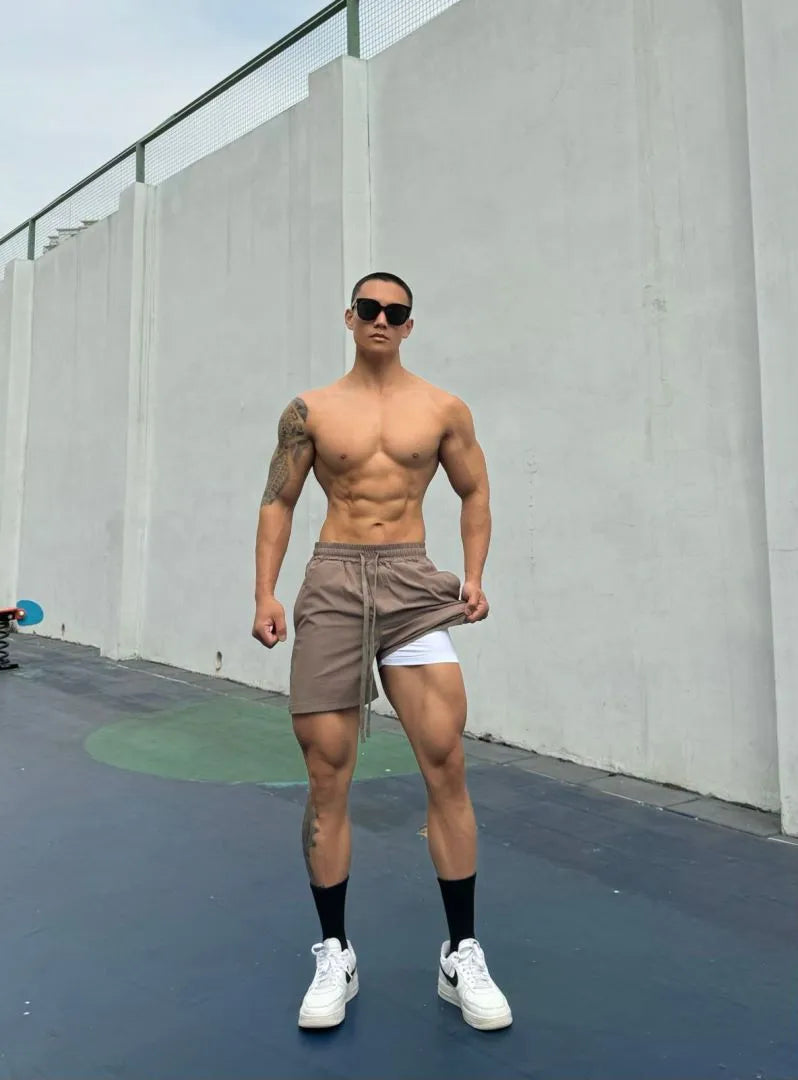 Men's quick-drying double-layer nylon shorts shown in multiple colours.