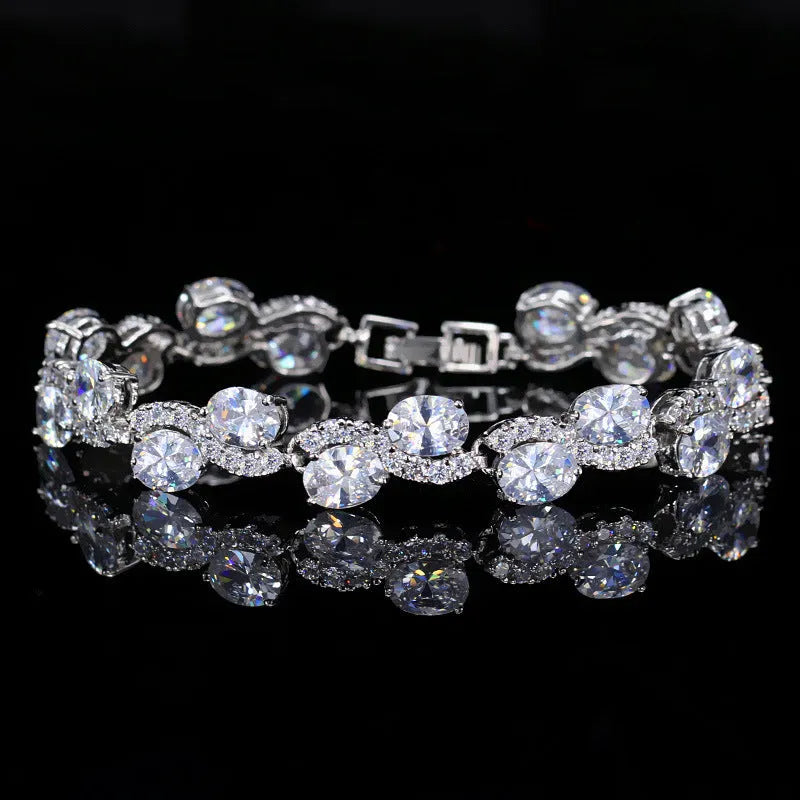 Geometric women's bracelet with zircon stones and gold-electroplated finish on copper base