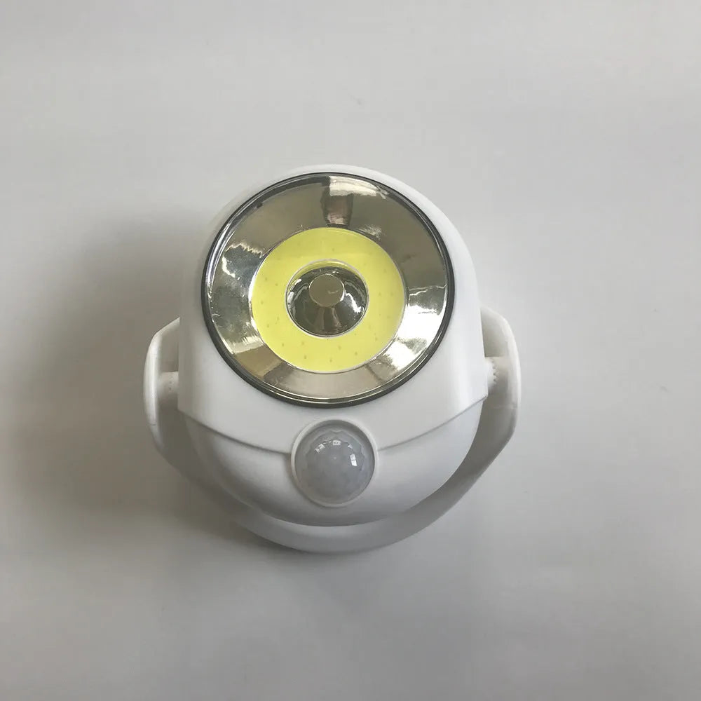 White Atomic Angel induction-powered night light with compact ABS plastic body.