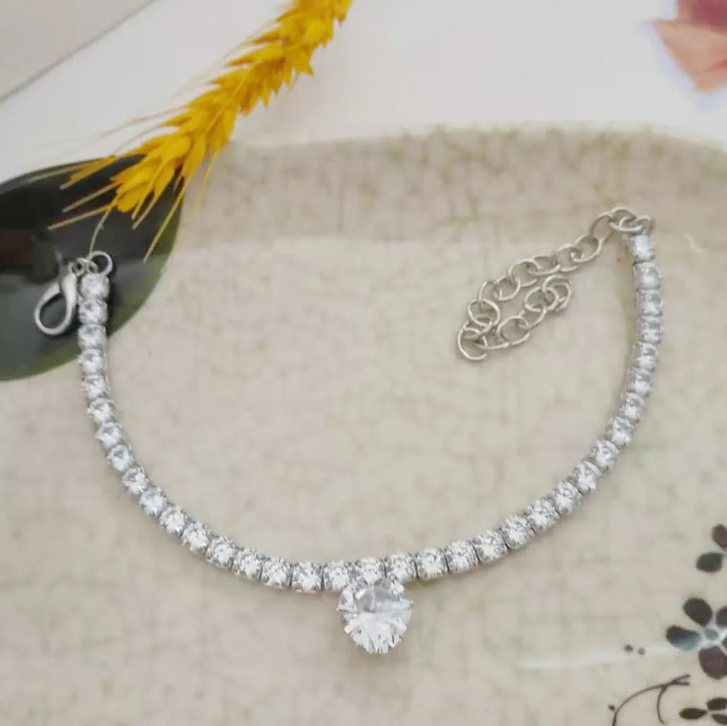 Gold heart-shaped rhinestone pet collar for dogs and cats with adjustable chain on a white background.
