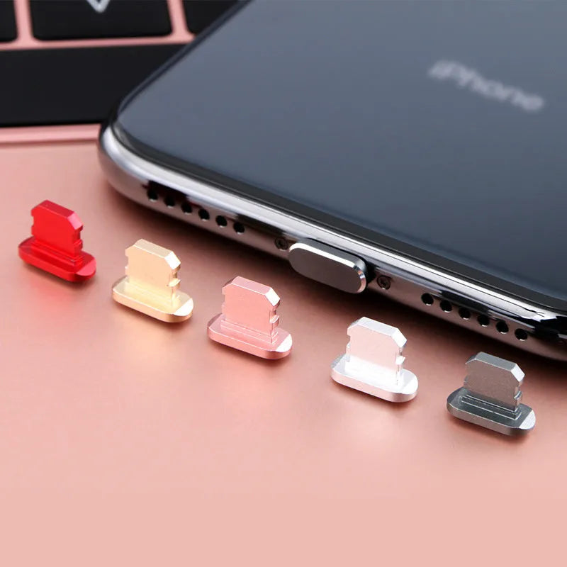 Aluminium alloy mobile phone charging port dust plug for iPhones, shown in rose gold colour.