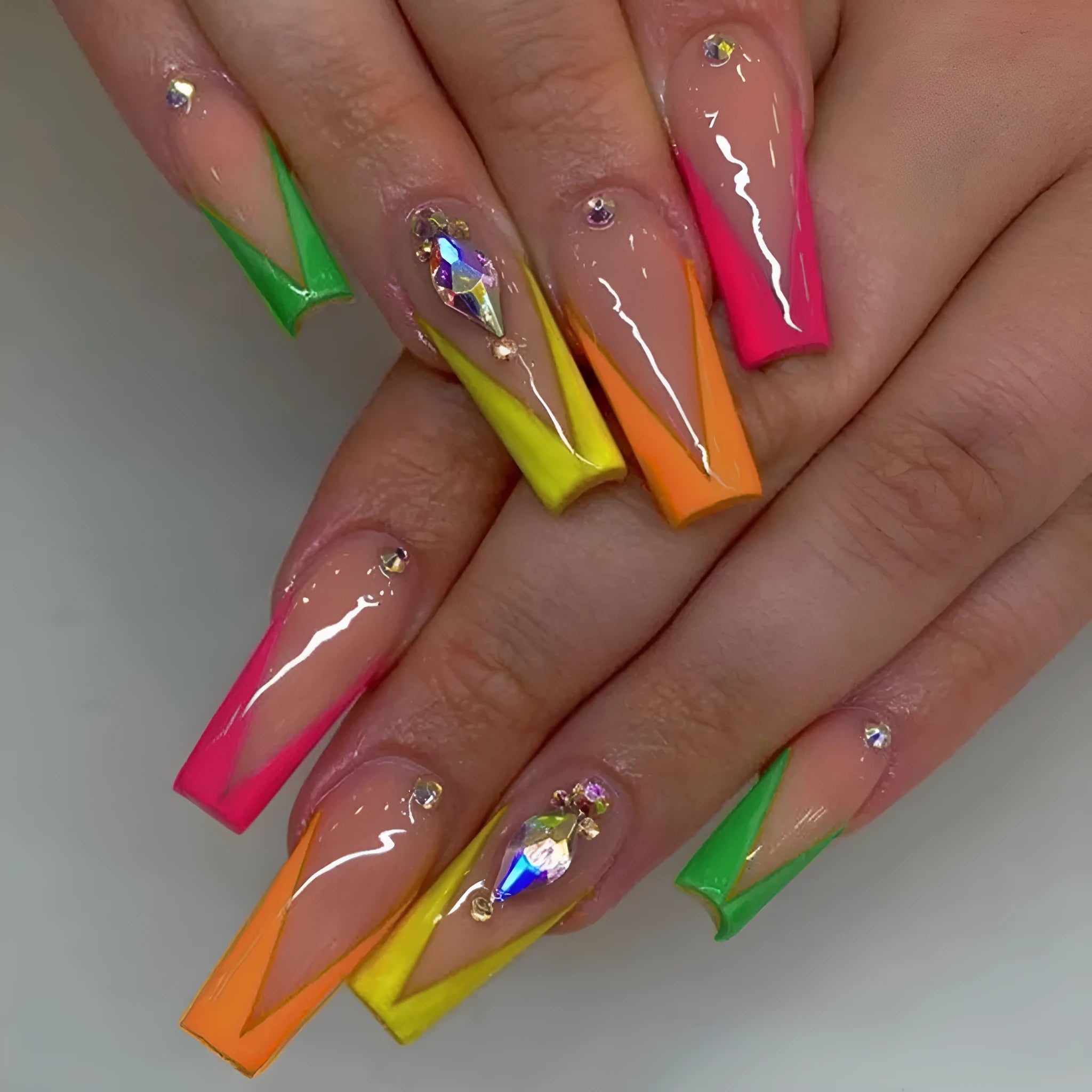 Detachable artificial nail tips with red cartoon love heart and cross design on diamond French colour background.
