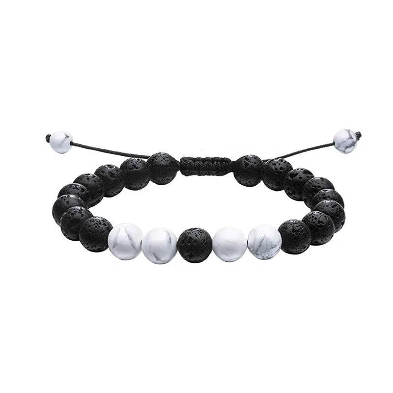 Pair of matte black agate bead bracelets with geometric design for couples.