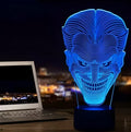 3D LED table lamp showing seven colour options with remote control and USB cable on wooden surface