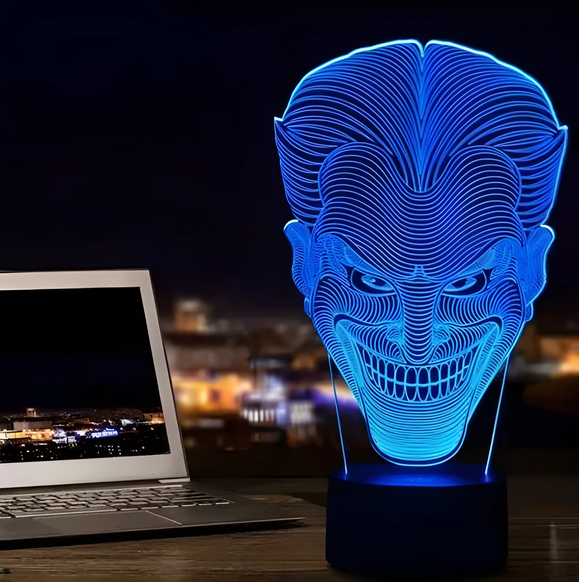 3D LED table lamp showing seven colour options with remote control and USB cable on wooden surface