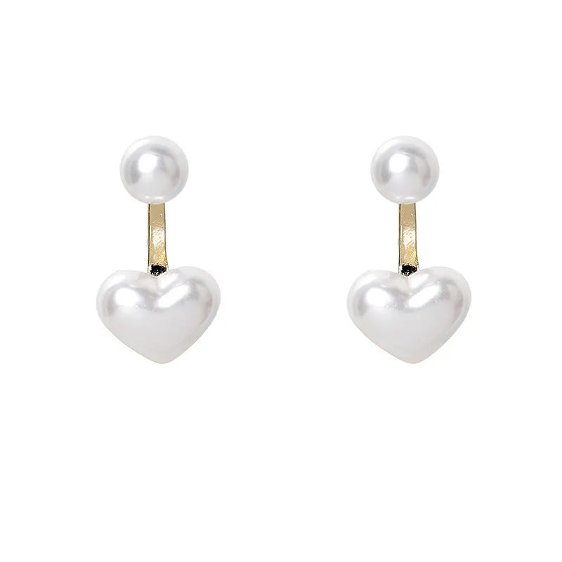 Korean style women's heart shaped stud earrings with pearl-like artificial gemstone inlay on a white background.