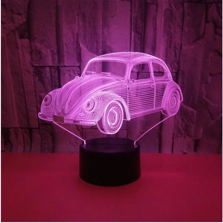 Small 3D LED table lamp with colourful acrylic shade and remote control on wooden desk