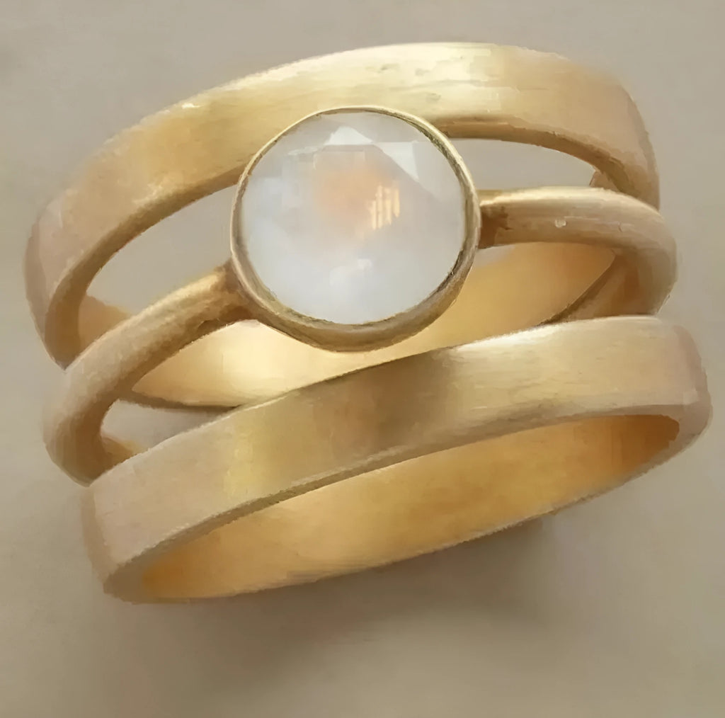 Gold geometric ring with hollow design and white chalcedony inlay on hand