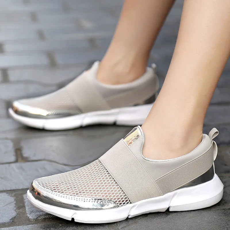 Blue, black, and grey women's low-cut mesh sneakers with a PU midsole on a hard floor.