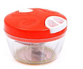 Green manual kitchen chopper with stainless steel blades and a clear lid, showing its compact size.