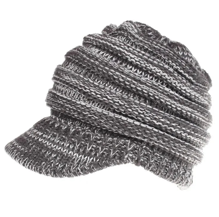 Woman wearing a soft knitted beanie with a ponytail pulled through the hole at the back.