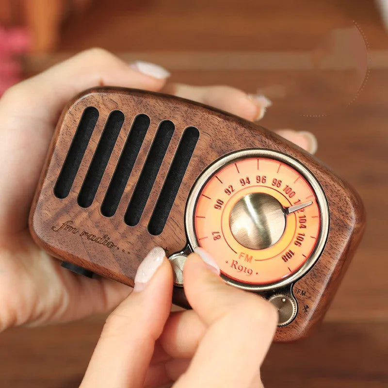 Retro wooden wireless mini speaker in cherry wood finish showing front and side.