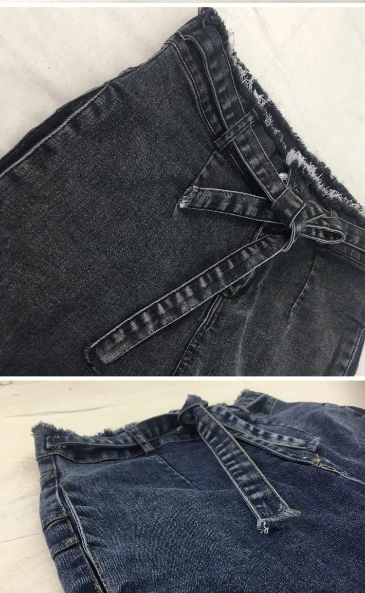 Pair of women's light blue straight-leg jeans with a frayed, distressed hem detail.