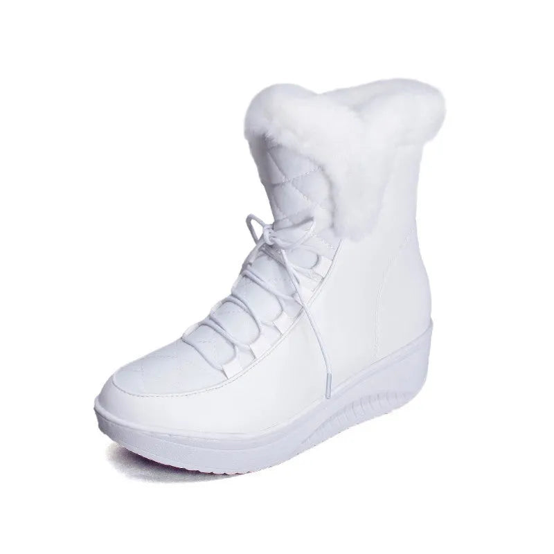 Women's black lace-up winter boots with a platform sole and plush lining on a wooden floor.